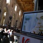 Delegates packed St. John Lateran for the morning sessions Thursday. On the bill was a series of Divine Mercy testimonies. Above, Cardinal Barbarin of France is shown on one of the many video screens situated throughout the basilica.