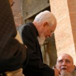 Father Seraphim Michalenko, MIC, left, greets Fr. Benedict Groeschel, following the workshops on Thursday at Our Lady of the Angels.