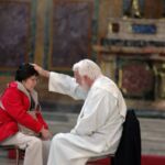 In a world congress dedicated to mercy, a pilgrim turns to the "Fount of Mercy," the Sacrament of Reconciliation, at Our Lady of the Angels in Rome on Friday.