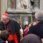 Cardinal Christoph Schonborn, Bishop of Austria and general moderator of the world congress, greets people during a break in Friday's morning session at St. John Lateran.