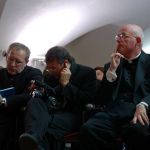 U.S. Mercy Congress organizers Fr. Matthew Mauriello (right) of the Diocese of Bridgeport, Conn., and Fr. Kaz Chwalek, MIC, to his right, listen in during a post-congress meeting of planners on Sunday.