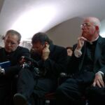 U.S. Mercy Congress organizers Fr. Matthew Mauriello (right) of the Diocese of Bridgeport, Conn., and Fr. Kaz Chwalek, MIC, to his right, listen in during a post-congress meeting of planners on Sunday.