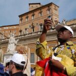Father Prince Adelaayitar of Ghana captures the moment during the opening procession on April 2.